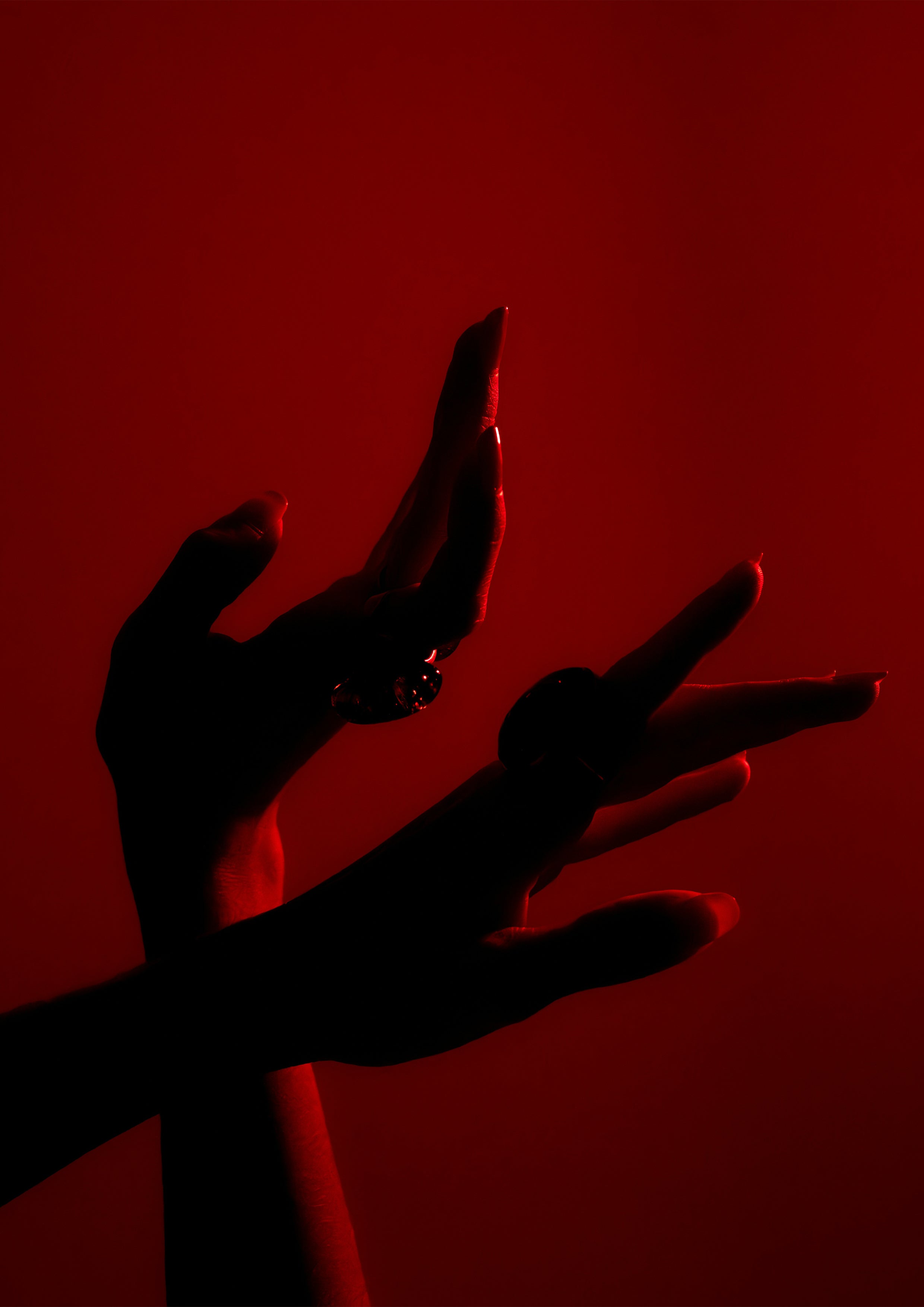 Silhouette of a hand against a red background