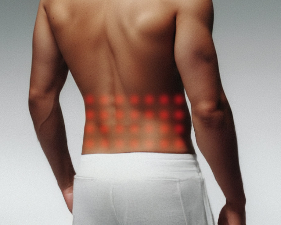 Man with red glowing spots on his back, indicating a red light therapy session.