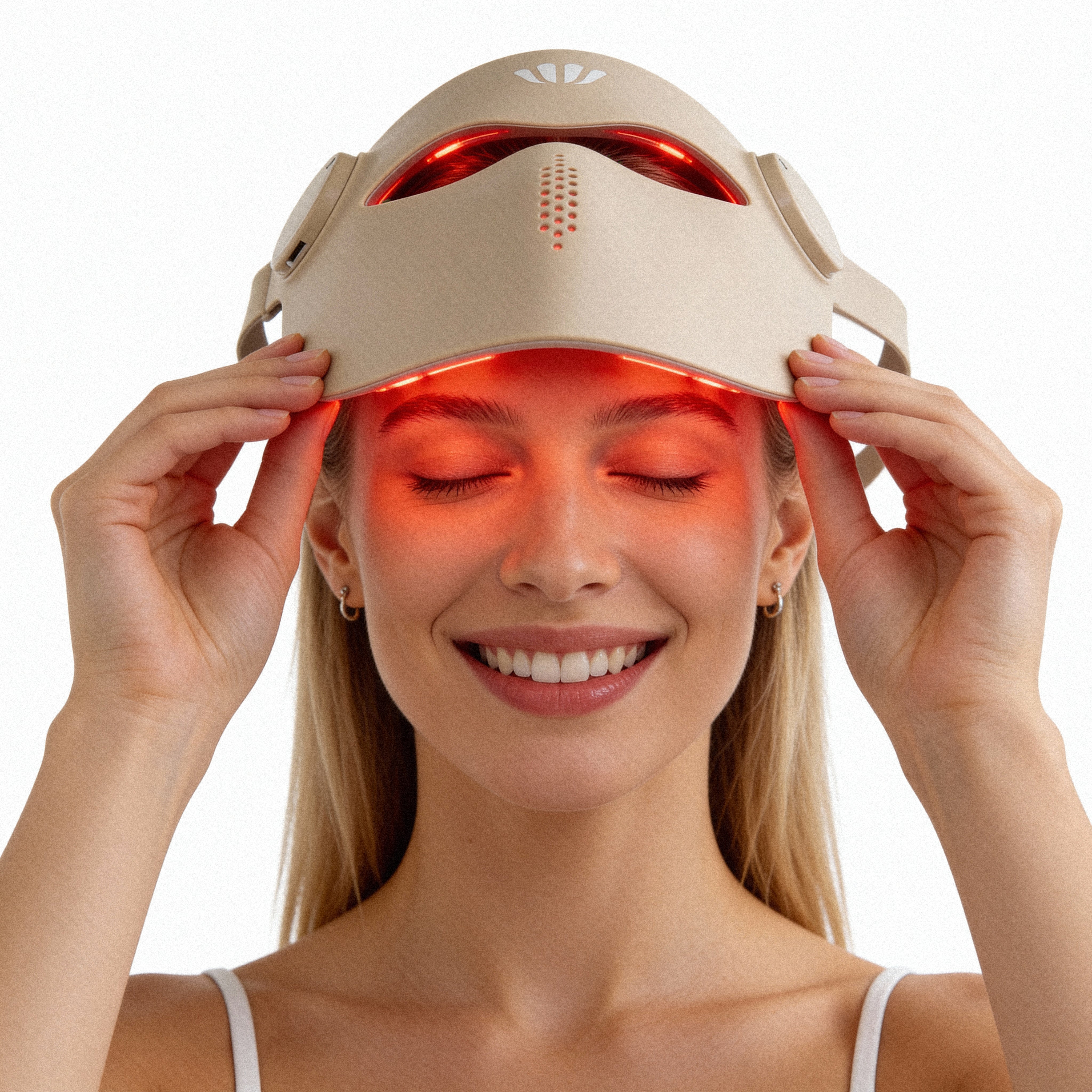 Woman wearing a beige silicone red light therapy facemask headlight device on a white background