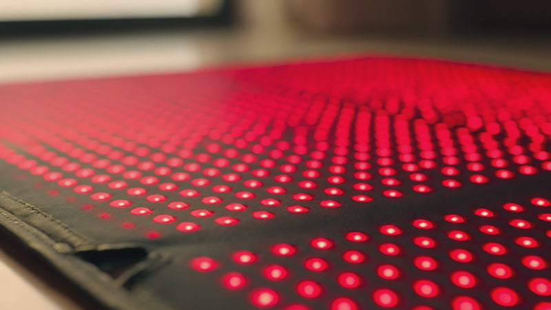 Woman lays on a red light therapy pad in Switzerland