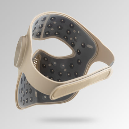 Beige silicone red light therapy facemask with textured LED on a light gray background